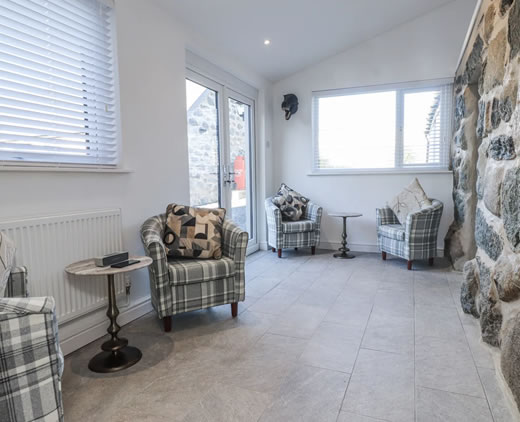 Snug room with armchairs at Ty'n Lon near Chwilog